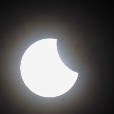 Skygazers catch glimpse of partial solar eclipse